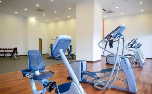 a gym with several exercise equipment in a room at Silverscape Seaview Residence Melaka in Melaka