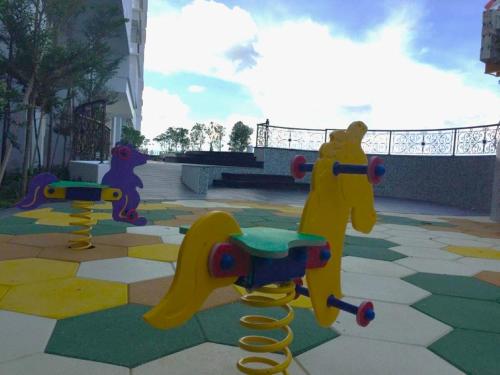 a rendering of a playground with two play equipment at Silverscape Seaview Residence Melaka in Melaka