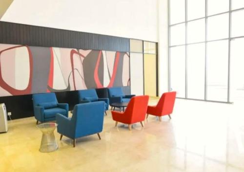 a group of chairs and a table in a room at Silverscape Seaview Residence Melaka in Melaka
