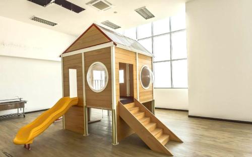 a play house with a slide in a room at Silverscape Seaview Residence Melaka in Melaka