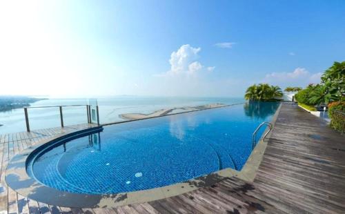 a swimming pool with a view of the ocean at Silverscape Seaview Residence Melaka in Melaka
