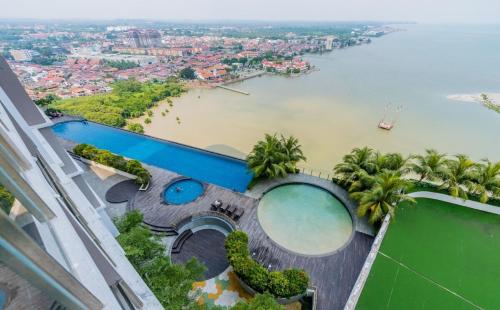 an aerial view of a river and a building at Silverscape Seaview Residence Melaka in Melaka