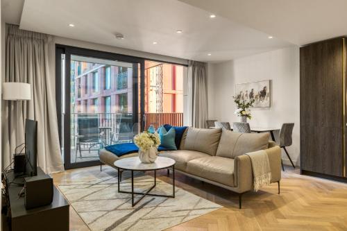 a living room with a couch and a table at Hyde Park Beauty 2BR 2BA Balcony in London