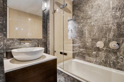 a bathroom with a sink and a shower and a tub at Hyde Park Beauty 2BR 2BA Balcony in London