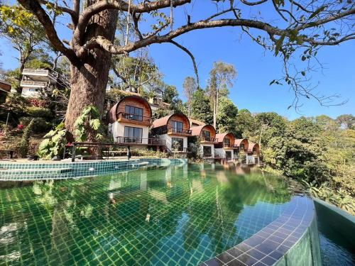 an image of a resort with a swimming pool and a tree at Baan Nhuer Mek บ้านเหนือเมฆ Coffee and Desk on the Cloud in Ban Pang Klang
