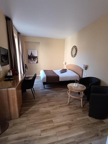a hotel room with a bed and a couch and a table at Hôtel Du Théâtre Centre Historique - Parking Souterrain Public Gratuit in Metz