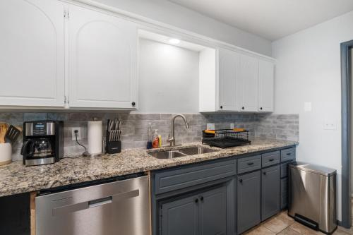 a kitchen with white cabinets and a sink at Spacious 8 Bedrooms Retreat Pool Table #08 in Bethany