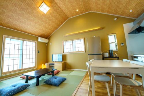 a living room with a table and a dining room at Modern Japanese House in Musashi-Kosugi, 3BR, 15 Guests, Family Friendly in Kawasaki