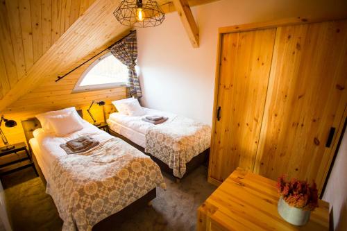 Postel nebo postele na pokoji v ubytování Apartamenty Szelągówka, Sun & Snow