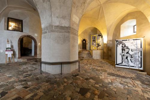 a room with a bench in the middle of a building at Castel Pergine in Pergine Valsugana