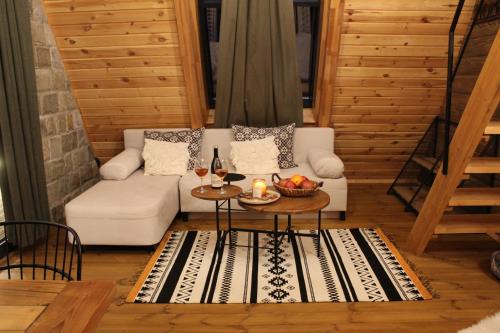 a living room with a white couch and a table at Dakota forest retreat in Tsigov Chark