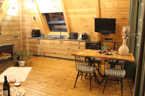 a room with a table and chairs and a television at Dakota forest retreat in Tsigov Chark