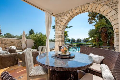 an outdoor patio with a table and chairs at Villa Magnolia Umag in Umag