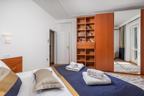a bedroom with a bed with two towels on it at Villa Magnolia Umag in Umag