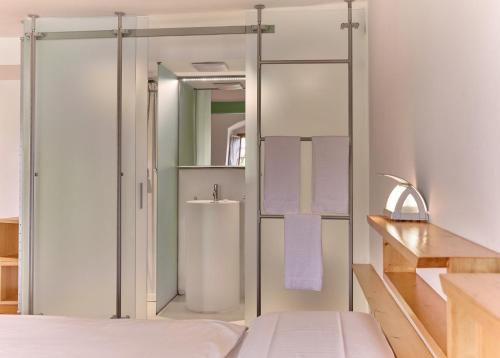 a bathroom with a glass shower door with towels at Castel Pergine in Pergine Valsugana