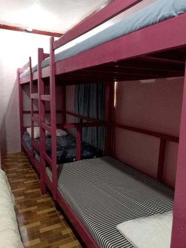 a couple of bunk beds in a room at Little Bridges in Mambajao