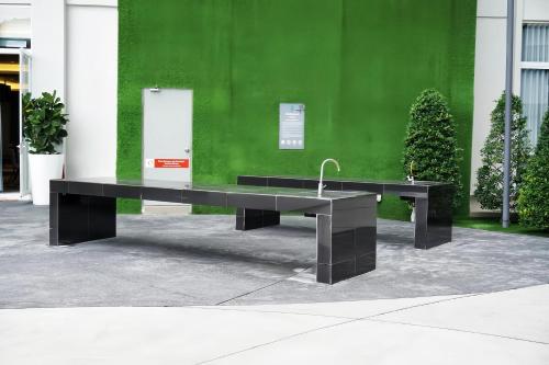 a black bench in front of a green wall at Windmill Upon Hills Genting Highland in Genting Highlands