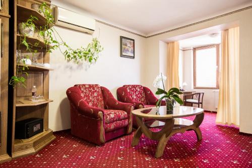 a living room with a couch and a table at Bukovyna Hotel in Chernivtsi