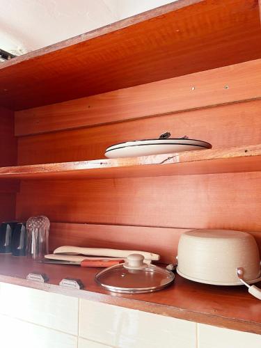 a shelf with a pot and a plate on it at Kara's place in Nairobi