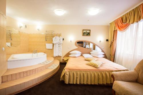 a bathroom with two beds and a bath tub at Bukovyna Hotel in Chernivtsi
