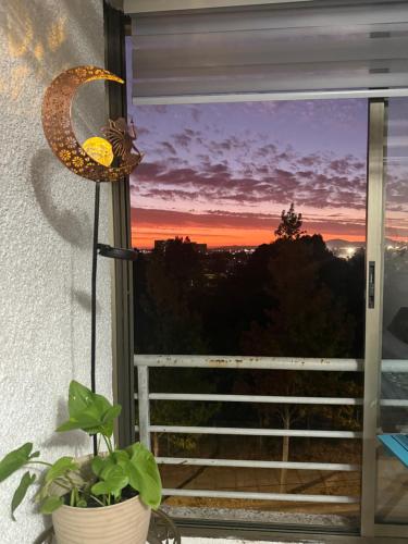 a window with a view of a sunset at Vista Laguna Redonda in Concepción