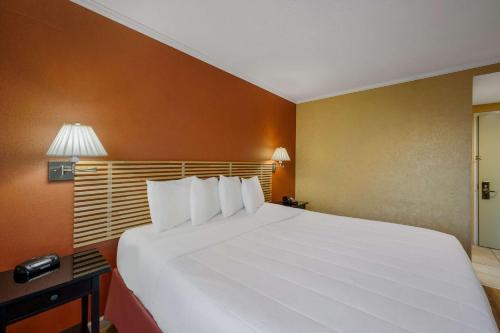 a large white bed in a hotel room at Quality Inn JFK Airport Rockaway Blvd in Queens