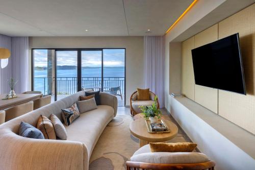 a living room with a couch and a flat screen tv at Waldorf Astoria Costa Rica Punta Cacique in Playa Hermosa