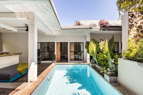 a swimming pool in the backyard of a house at Villa The Jambu in Tumbak Bayuh