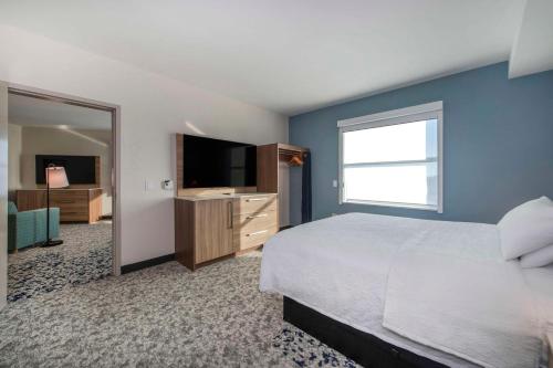 a bedroom with a bed and a flat screen tv at Home2 Suites By Hilton Lumberton in Lumberton