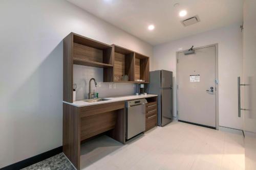 a kitchen with a sink and a refrigerator at Home2 Suites By Hilton Lumberton in Lumberton