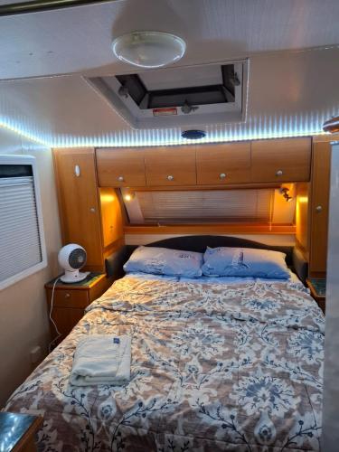 a bedroom with a large bed in a motor yacht at Caravan at 36 Clarevale in Clayton North