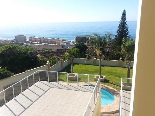 a balcony with a view of the ocean at The Homestead Margate - South Africa in Margate