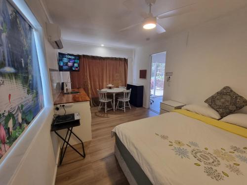 a bedroom with a bed and a dining room with a table at Mountain Creek Retreat in Mountain Creek