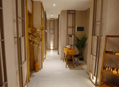 a hallway with a long corridor with vases and a table at Platinum Hotel Jimbaran Beach Bali in Jimbaran