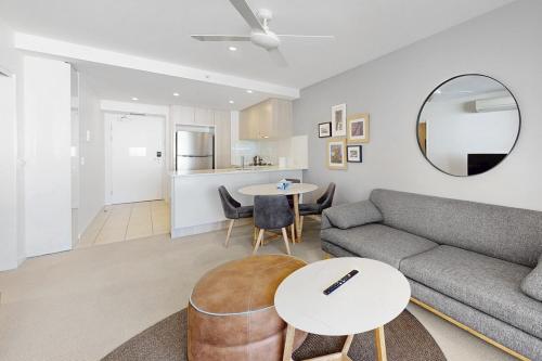 a living room with a couch and a table at Charming Hamilton Retreat in Brisbane