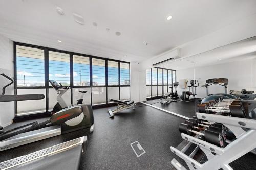 a gym with several treadmills and exercise bikes at Charming Hamilton Retreat in Brisbane