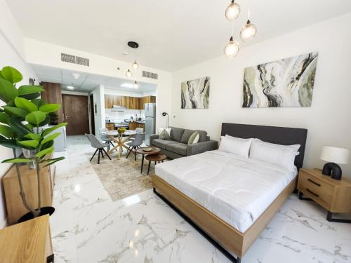 a bedroom with a bed and a living room at Marina Residences Al Hamra Village in Ras al Khaimah