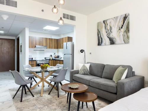a living room with a couch and a table at Marina Residences Al Hamra Village in Ras al Khaimah