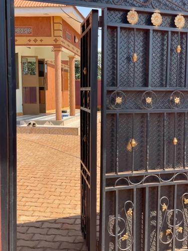 an open gate with a building in the background at Buwagi Home away from Home in Bugembe