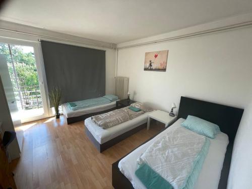 a bedroom with two beds and a window at ROOMS Vystaviste BVV in Brno