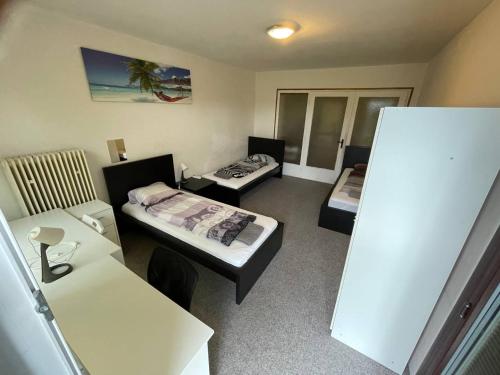 a room with two beds and a table and a desk at ROOMS Vystaviste BVV in Brno