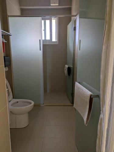 a small bathroom with a toilet and a shower at Sleep Melon Homestay in Taitung City