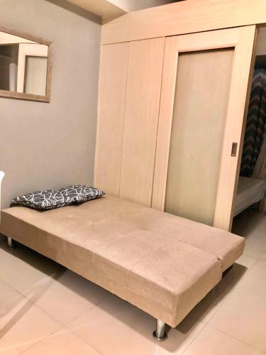 a bed sitting in a room with at Cosy Light Residences Unit Staycation in Manila