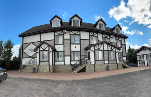 a large building with a gambrel roof at Edelhof in Karagandy
