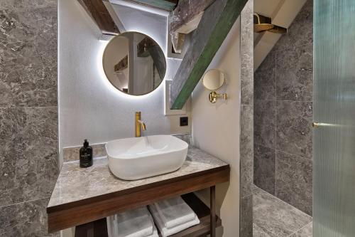 a bathroom with a sink and a mirror at The Saints Hotel in Den Bosch