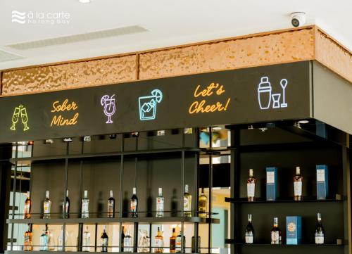 a display of bottles of wine on a shelf at A La Carte Ha Long Bay Managed by TASECO in Ha Long