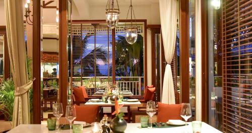 a restaurant with tables and chairs and a large window at Sofitel Krabi Phokeethra Golf and Spa Resort in Klong Muang Beach
