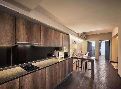 a kitchen with wooden cabinets and a counter top at Tropics Eight Suites in George Town