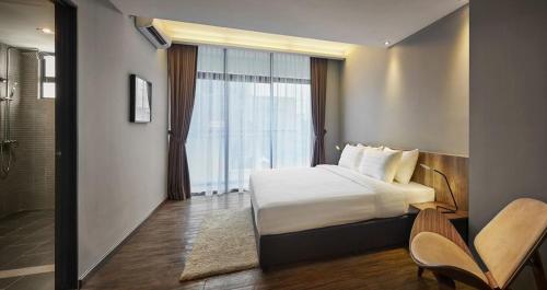 a hotel room with a bed and a shower at Tropics Eight Suites in George Town
