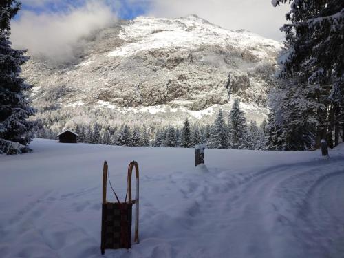 a snow covered mountain with skis in the snow at Hotel Garni Isarlodge Wiesenhof in Scharnitz